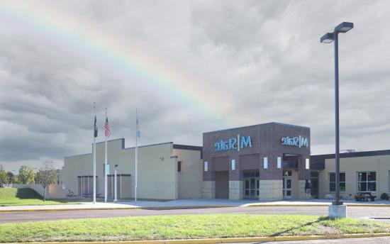 A photo of the exterior of M State-Wadena with a rainbow occurring over the building 